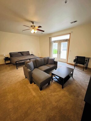 Wide View of Studio Living area, Dedicated Work Space, and Sleeping Area