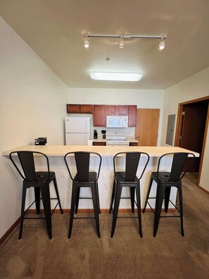 View of Kitchen and Dining Counter with Stools