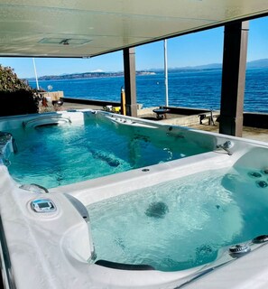 Rest and relax, right on the waterfront while sitting in this unique, hot tub and pool all in one! The hot tub fits for adults, the swim spa fits 6 to 8 adults comfortably.