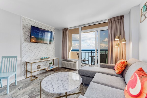 Relax and unwind in our spacious living room with panoramic views of the Atlantic Ocean!