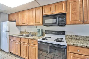 Showcase the elegance of coastal cuisine with a well-appointed kitchen, complete with stylish cabinetry, modern appliances, and thoughtful design.