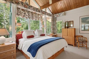 The master bedroom is located on the top floor and has vaulted ceilings, a king bed, an en-suite bath with a separate sitting area and TV.