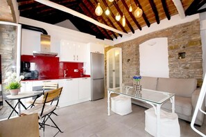 Another view of the lounge with dining area for two and open kitchen