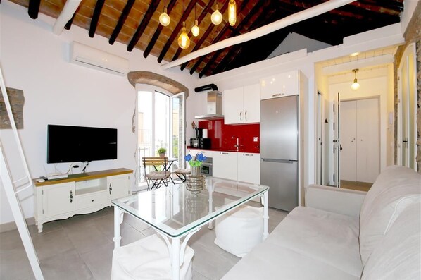 Bright and modern lounge area with open kitchen to the rear