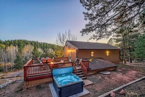 Back of house hosts the hot tub and large porch