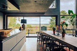Dining area and kitchen area looking out to views 