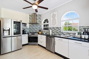 Cook up a storm in a fully equipped kitchen, perfect for gourmet meals and family feasts - Discover the joy of home-cooked meals in a kitchen with stainless steel appliances - Featuring sleek countertops and plenty of storage