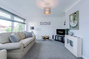 The spacious living space benefits from a 40-inch smart TV and plenty of space to sit down and relax.