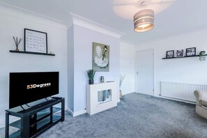 The spacious living space benefits from a 40-inch smart TV and plenty of space to sit down and relax.