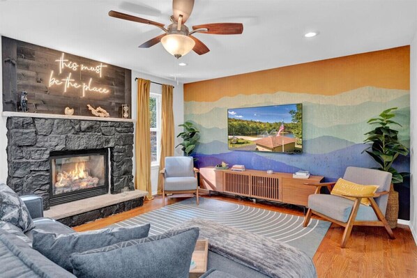 Cozy Comfort: Gather Around the Fireplace in Our Inviting Living Room with Ceiling Fan Ambiance 🔥🌀 #HomeAwayFromHome #CozyVibes