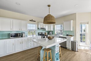 A clean, modern kitchen with stainless steel appliances and a spacious island.