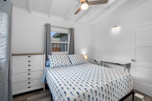 The bed's sleek, modern frame blends seamlessly with the room's warm, neutral color palette, creating a serene atmosphere ideal for unwinding after a long day.