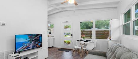 Central to the living area is the smart TV, mounted on the wall to optimize space and viewing angles.