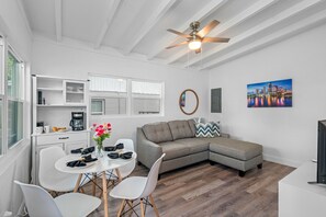 During the day, natural light floods in through large windows, illuminating the room and highlighting its tasteful decor.
