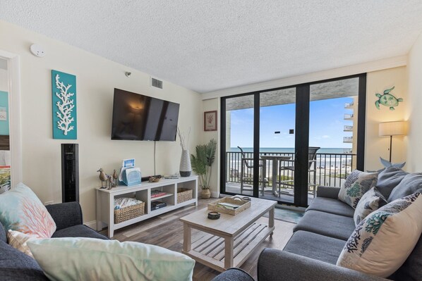 After a day of sun and surf, unwind in the ocean-view living room, equipped with a comfortable sofa sleeper, a smart TV, and sliders leading to the balcony.