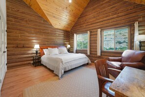 Relax in the master bedroom featuring a king-size bed, vaulted ceilings, and stunning Provo Canyon views