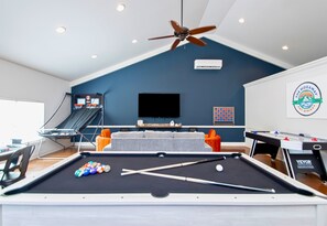 The game room is a hub of fun, featuring a pool table and various other games for endless entertainment.