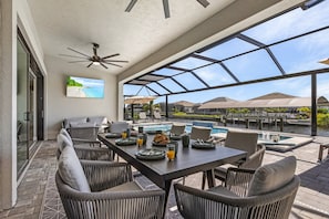 Enjoy outdoor dining with stunning canal views in a spacious, covered patio area.