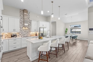 Sleek, modern kitchen with bar seating and top-of-the-line appliances for gourmet meals.