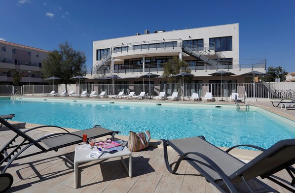 Lounge by the pool in the sunshine.