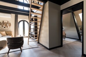 Air-conditioning unit in living room space, and doorway to the downstairs bedroom