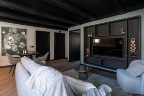 Cable TV in living room area and the door to the bedroom and bathroom