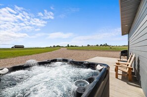 Indulge in the ultimate outdoor experience with our hot tub, BBQ grill, and scenic seating area
