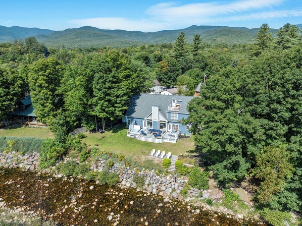 Wake up to stunning mountain views and the sound of the river just steps from your door. This peaceful waterfront retreat offers a spacious deck, cozy seating, and direct access to nature. Perfect for a relaxing escape.