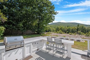 Enjoy outdoor dining and grilling with breathtaking mountain views. This spacious deck offers the perfect spot for al fresco meals or relaxing with a drink while taking in the serene natural surroundings