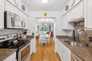 To your left from the entrance, a fully-equipped kitchen awaits. The open-concept living and dining area ensures that everyone in the group stays included in the conversation and admires the culinary adventures of the chef among you.
