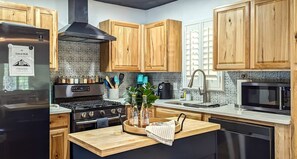 Our well stocked kitchen invites you to make yourself at home here.