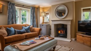 Relax in the living room beside the gentle crackle of the fire