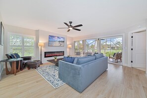 Bonita Bay #1 - Living with electric fireplace and TV. Sliding doors open up to the screened in balcony