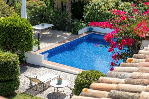 Private pool surrounded by lush garden