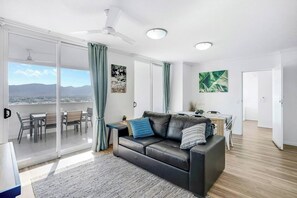 The first apartment features an open plan living area, highlighting sprawling vistas through sliding glass doors.