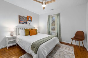 Bedroom with plush beddings and seating corner