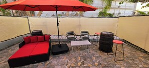 Backyard with daybed , large umbrella for shade and seating