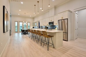 Gather around the expansive kitchen island, perfect for entertaining and family meals