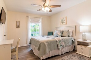 Bedroom 1 with queen bed, desk, smart tv, and ensuite