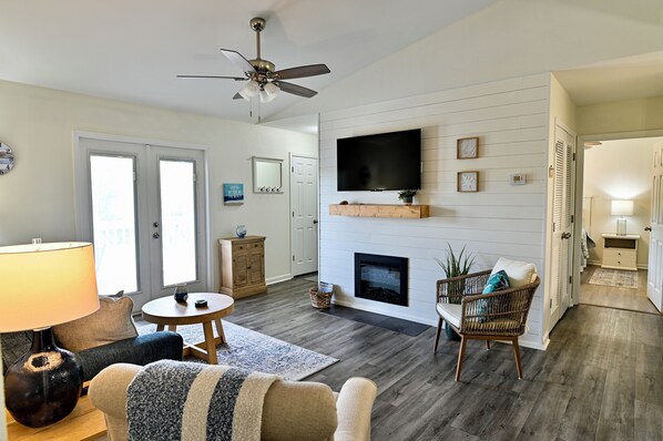 Living area with cozy seating, smart tv, and balcony access