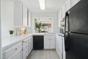 Spacious kitchen with a view into the living room and courtyard