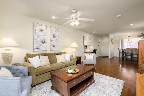 Living room has a sofa bed couch and two side chairs.