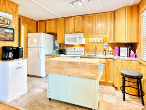 Full kitchen. Island shelf pops up for dining!
