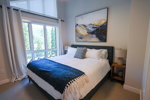 Bedroom 1 on the 3rd floor with views of the forest, creek and mountains.