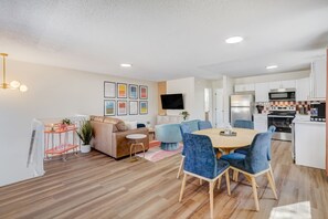 Experience the best of both worlds in our living room, where a smart TV meets the convenience of a nearby dining table for shared meals and entertainment