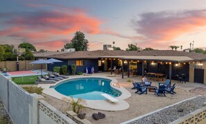 Our backyard transforms into a sunset haven, where the warm glow of twilight enhances every corner of your outdoor escape