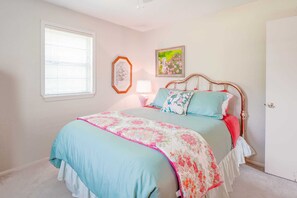 The room exudes a calm and welcoming ambiance, enhanced by its delightful floral accents.