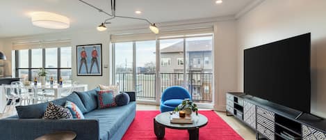Living room off the balcony featuring a sleeper sofa.