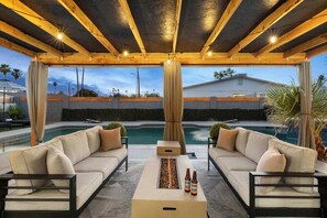 Enjoy the outdoor seating area with a firepit, perfect for relaxing by the pool.