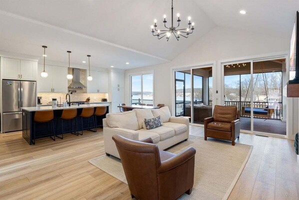 Bright and modern living room featuring a cozy fireplace, comfortable seating, and a stylish, open design for relaxation.
